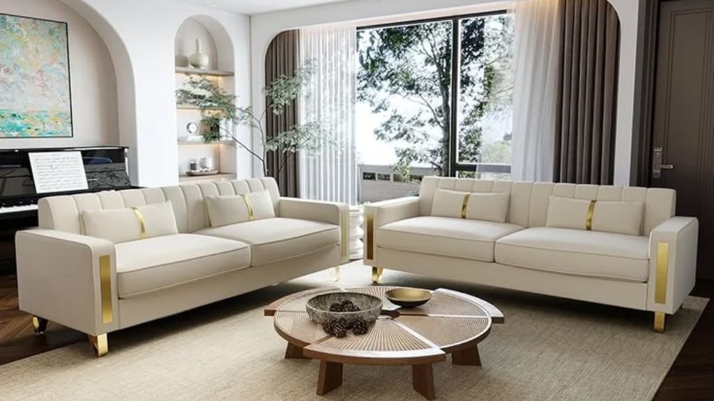 Elegant cream-colored seating with gold accents in a minimalist living room.
