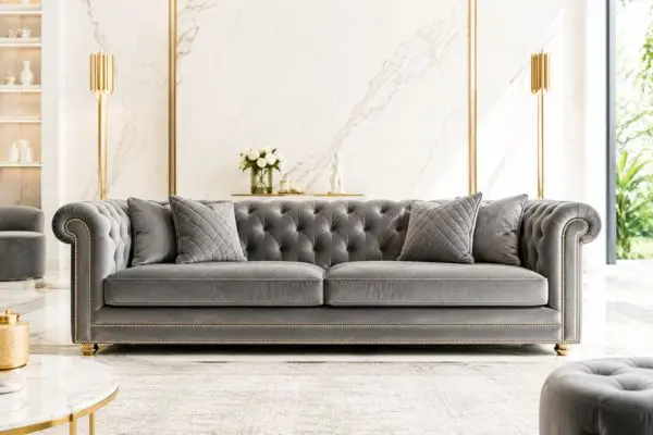Elegant tufted velvet furniture in a bright marble interior with gold accents