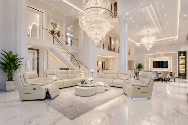 Cream beige leather sofa recliner set in a grand white luxury mansion living room