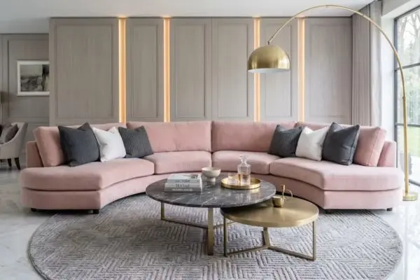 Styled blush pink velvet lounge decorated with a marble nesting coffee table and a circular rug