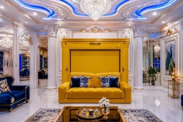 Royal yellow Murphy bed sofa in a luxury living room with blue neon wave ceiling.