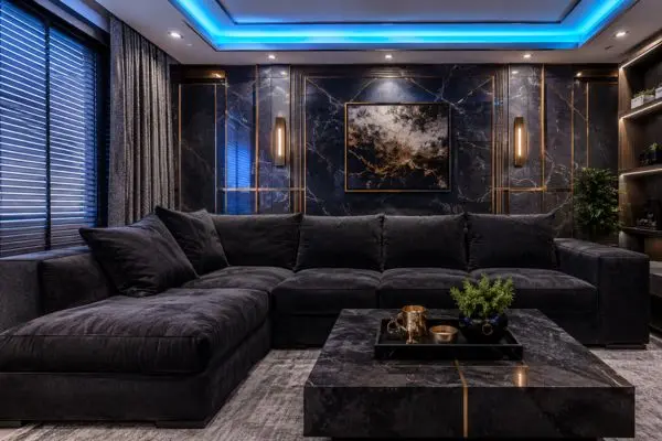 Oversized bulky dark charcoal sectional sofa crowding a small luxury room layout.