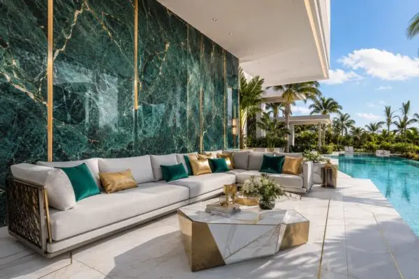 Luxury sectional seating with grey cushions on an emerald green marble patio