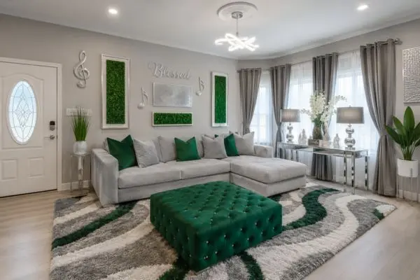 Light gray Ashley sofa chaise with emerald green pillows in a bright living room.
