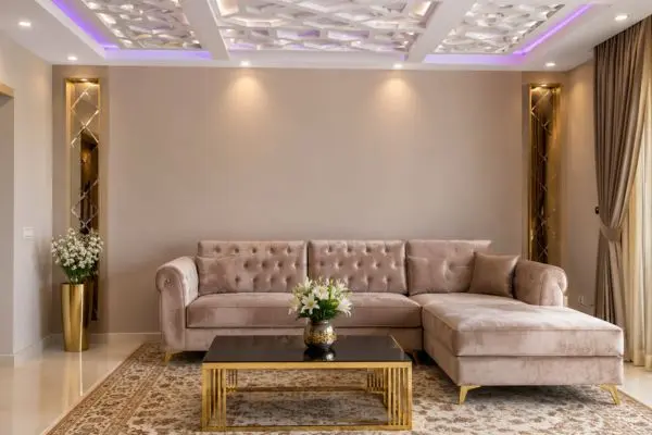 Taupe velvet small sectional sofa design under a modern decorative ceiling.