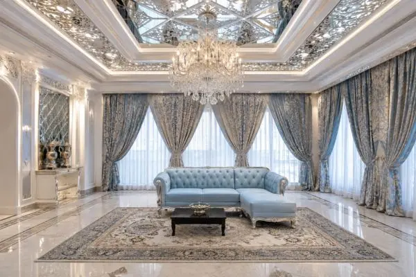 A single powder blue classic compact couch inside a majestic luxury hall room.