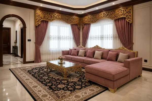 Dusty rose velvet traditional seating arrangement with gold carvings on a patterned rug.