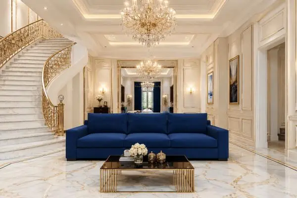A single standard modern azure seating lounge in a luxury mansion setup with a grand marble staircase.
