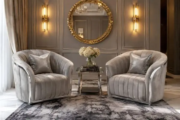 Two light grey velvet chairs with vertical channel tufting on an abstract textured rug.