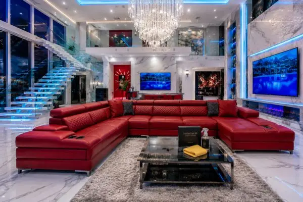 Step by step leather couch cleaning process setup in a luxury red and white living room.
