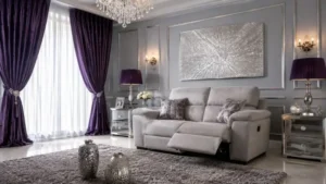 Modern small reclining sofa with extended footrest in a luxury purple and silver living room.