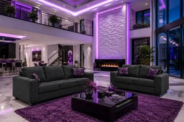 Charcoal gray 2 piece sofa set in a mansion living room with purple neon lights.