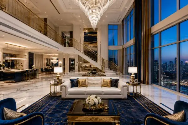 A pristine white and royal blue leather couch in a clean luxury penthouse.

