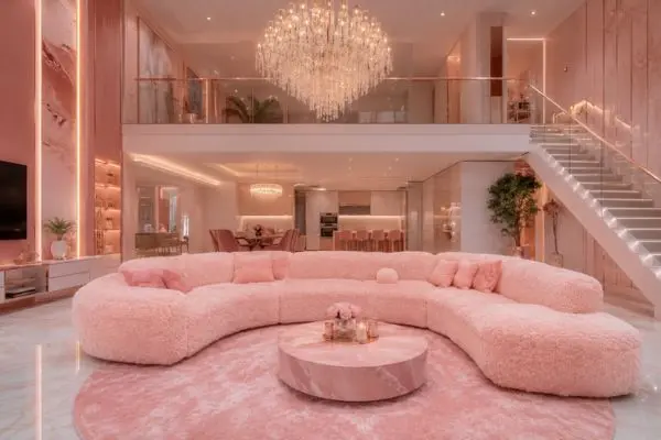 A single blush pink fluffy teddy sofa in a luxury modern double-height apartment